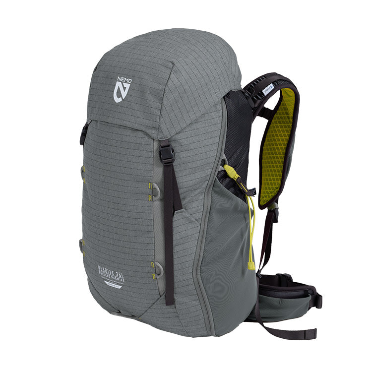 The NEMO Equipment Resolve™ Men's 35L Endless Promise® Technical Overnight Backpack stands upright against a white background, featuring gray fabric, black straps, yellow interior padding, side pockets, and a sternum strap.